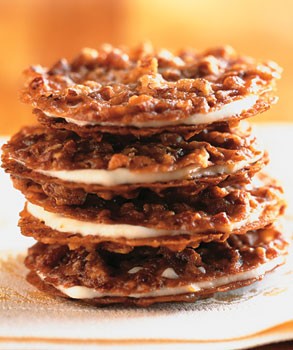 Pecan lace sandwich cookies with orange buttercream