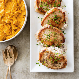 Pecan-stuffed pork chops with mashed sweet potatoes