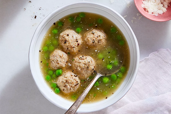 Pecorino dumplings in chicken broth with something green