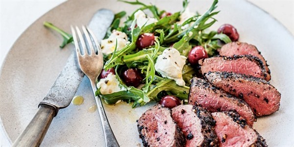 Pepperberry-crusted venison with pickled cherries