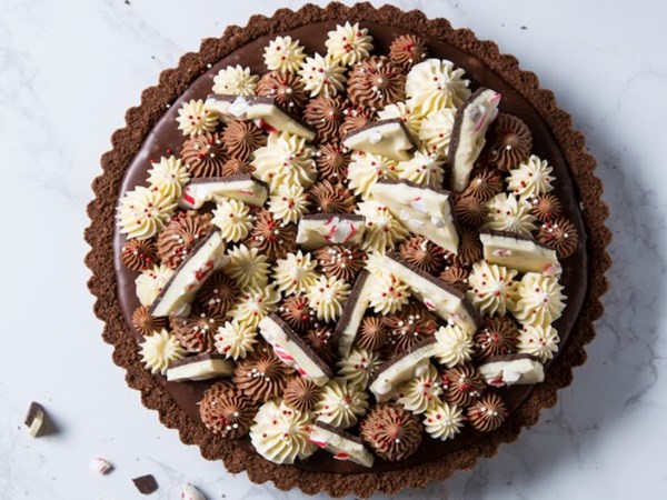 Peppermint bark and milk chocolate tart with Swiss meringue buttercream