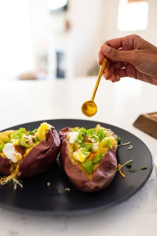 Perfect messy baked potatoes with turmeric oil drizzle