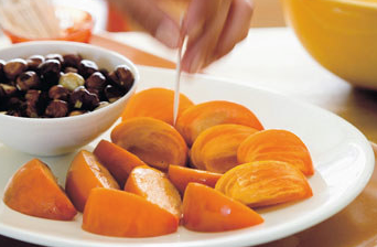 Persimmon wedges with toasted hazelnuts