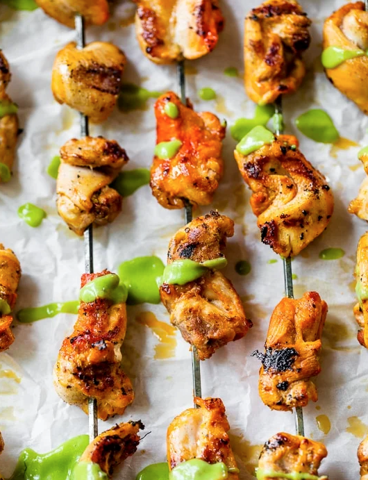 Peruvian-inspired grilled chicken skewers with avocado aji verde sauce