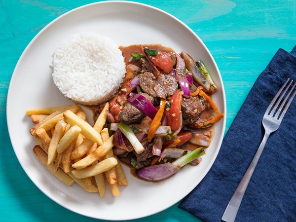 Peruvian stir-fried beef with onion, tomatoes, and French fries (Loma saltado)