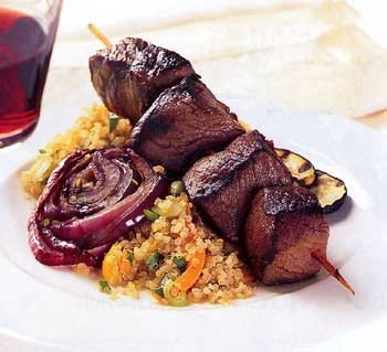 Peruvian-style beef kebabs with grilled onion and zucchini