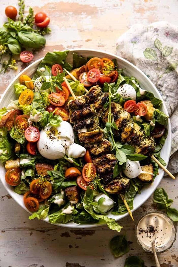 Pesto chicken Caesar salad with tomatoes and burrata