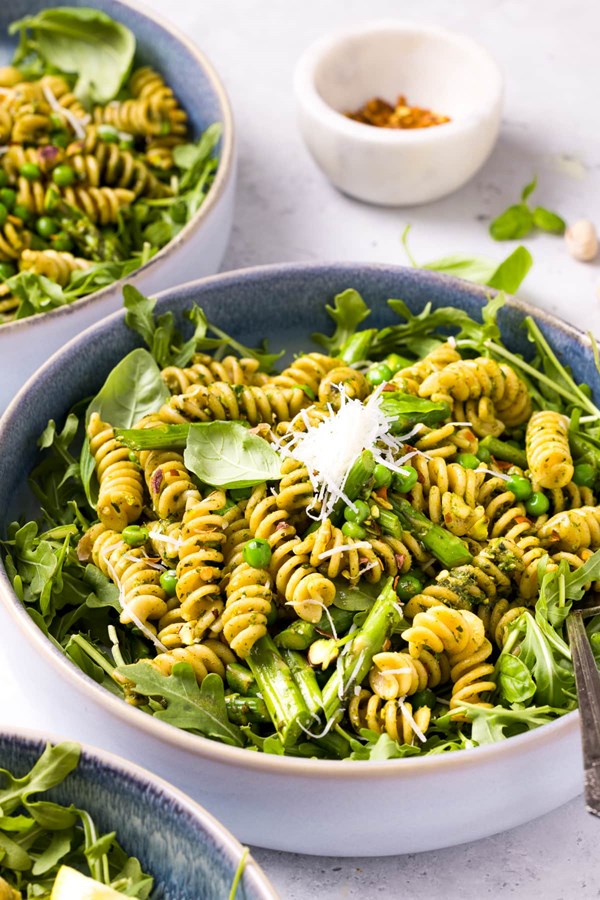 Pesto pasta with arugula, asparagus, peas, and pistachios