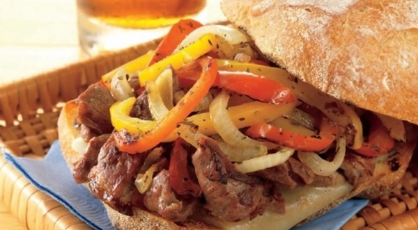 Philly-style steak sandwiches with grilled onions and provolone 
