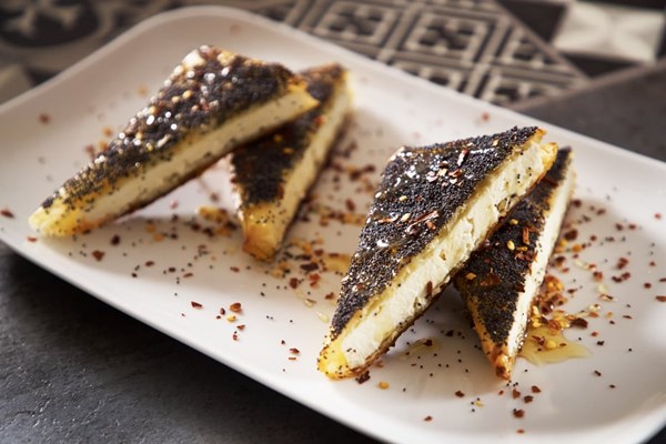 Phyllo-wrapped feta with cumin, poppy, or caraway seeds and honey (Feta psiti se fyllo me baharika kai meli)