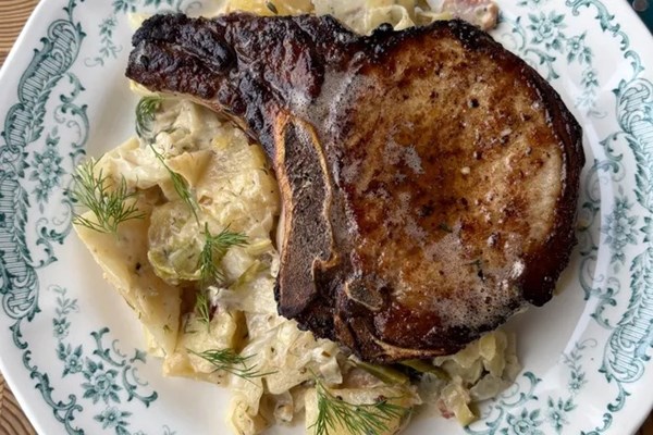 Pickle-brined pork chops with braised cabbage and potatoes