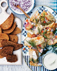 Pickled fried fish with Danish rye bread and crème fraîche