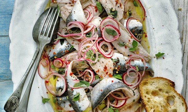 Pickled sardines with pink onions