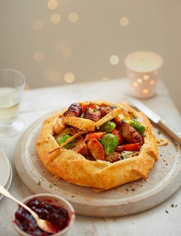 Pigs in blankets, sprouts, carrot and cheeseboard Béchamel galette