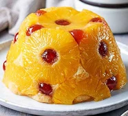 Pineapple & cherry sponge with coconut rum custard