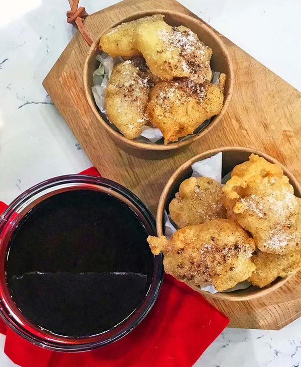 Pineapple fritters with hot bitter chocolate sauce