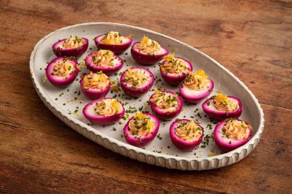 Pink devilled eggs with garlic and cayenne