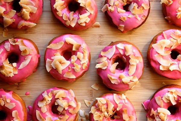 Pink raised doughnuts with toasted coconut