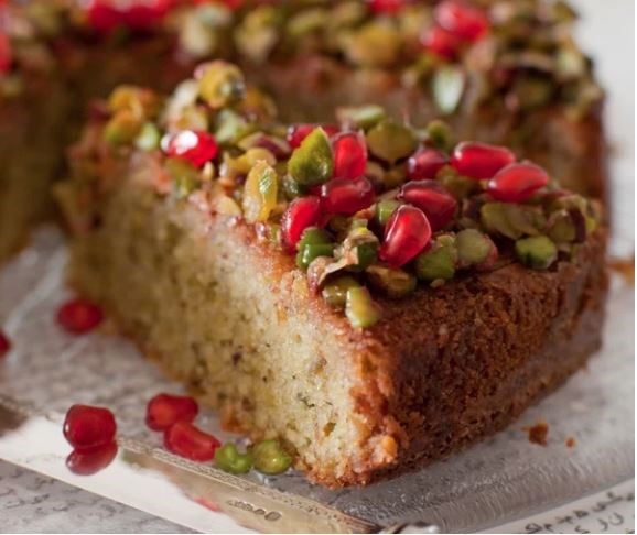 Pistachio and lime syrup cake with pomegranate seeds