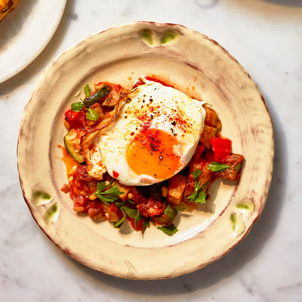 Pisto with sultanas, pine nuts and fried eggs