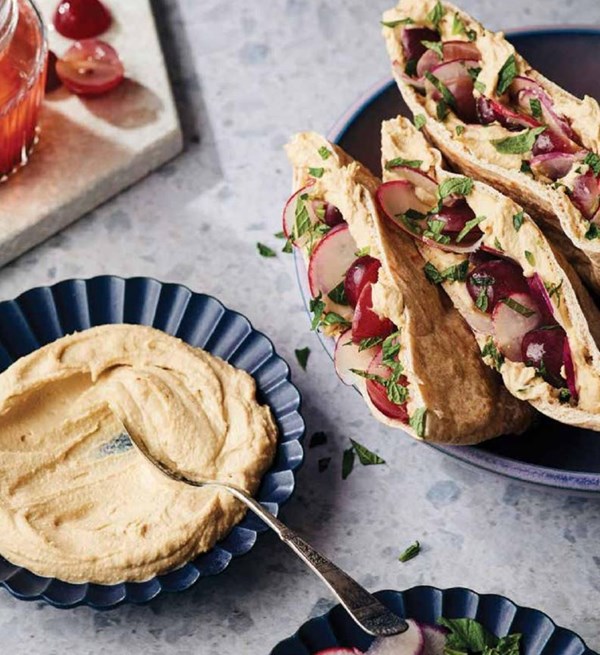 Pita stuffed with hummus, pickled grapes, radish, and mint
