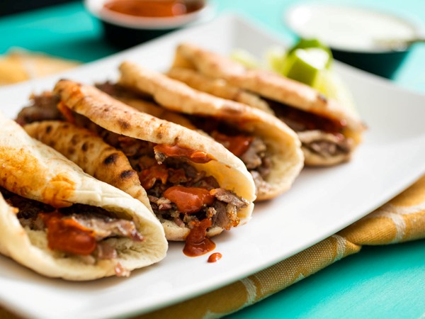 Pita-wrapped cumin-marinated-pork tacos (Tacos Árabes)