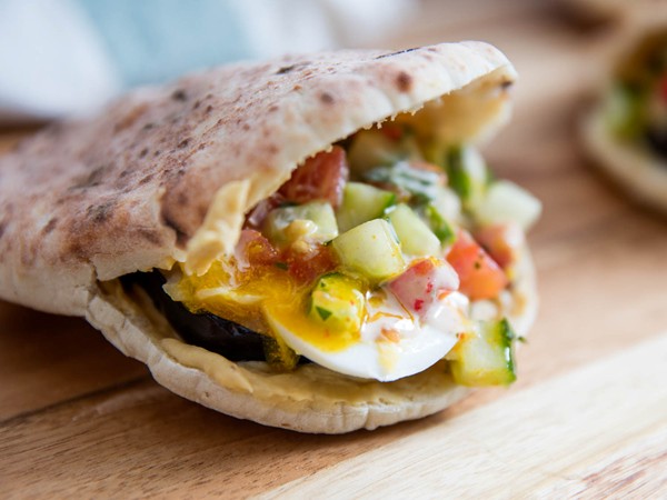 Pitas with eggplant, eggs, hummus, and tahini (Sabich sandwiches)
