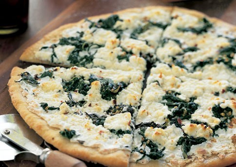 Pizza bianca with goat cheese and greens