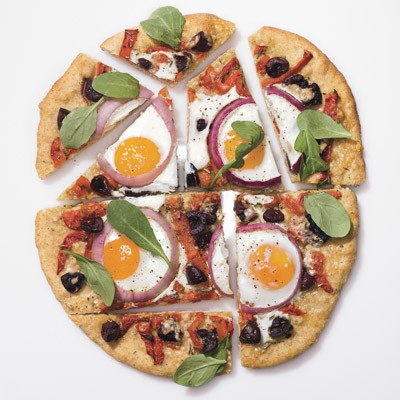 Pizza with eggs, roasted red peppers, olives, and arugula