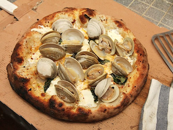 Pizza with fresh clams, garlic, mozzarella, Romano, and basil
