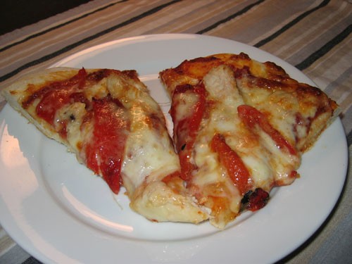 Pizza with grilled chicken, roasted red peppers, and Asiago cheese