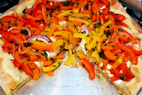 Pizza with red and yellow peppers