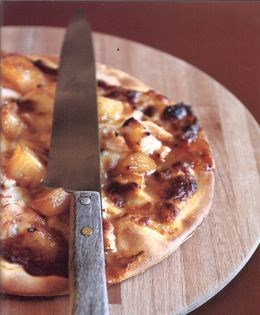 Pizza with smoked chicken, caramelized pineapple, and mozzarella cheese