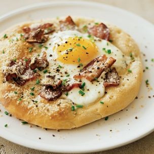 Pizzas with eggs and bacon