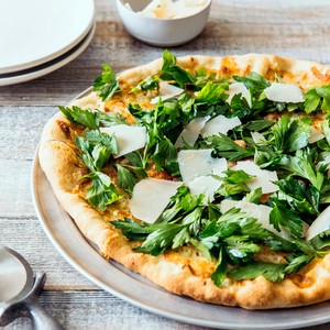 Pizzetta with parsley salad and shaved Parmigiano-Reggiano
