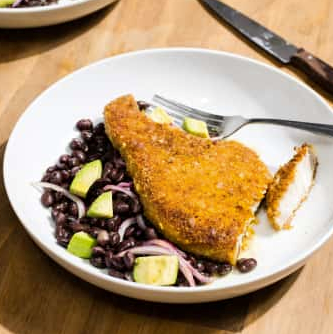 Plantain-crusted pork chops with black bean and avocado salad