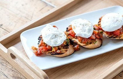 Plum tomato bruschetta with poached eggs