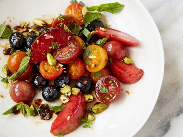 Plums, tomatoes, and blueberries in spiced pomegranate molasses dressing