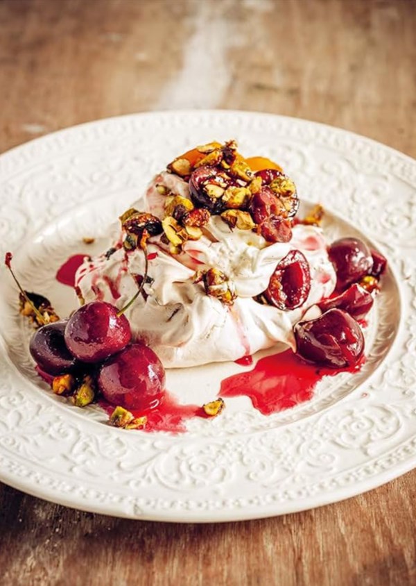 Poached cherry Pavlova, vanilla cream and toasted pistachios