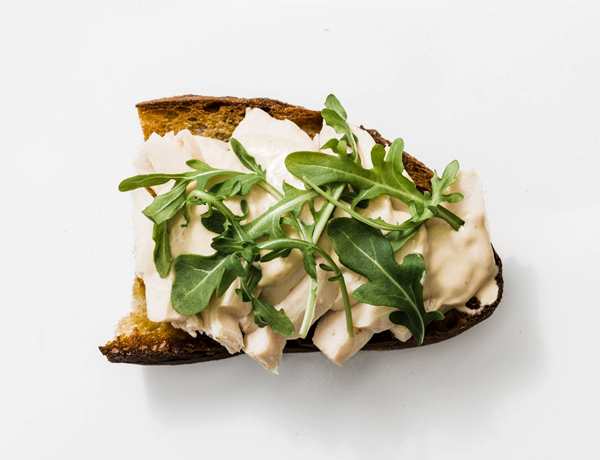 Poached chicken on toast with tonnato sauce and arugula