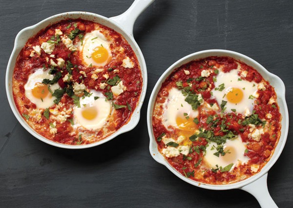 Poached eggs in tomato sauce with chickpeas and feta