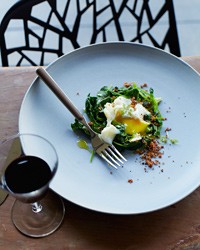 Poached eggs with bacon crumbs and spinach