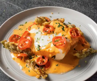 Poached fish fillets with crispy artichoke hearts and sherry-tomato vinaigrette