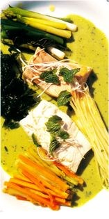 Poached halibut with steamed vegetables and green pea sauce