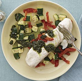 Poached halibut with sun-dried tomatoes, pesto, and zucchini