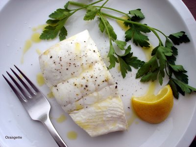 Poached halibut with sweet garlic, parsley, and lemon