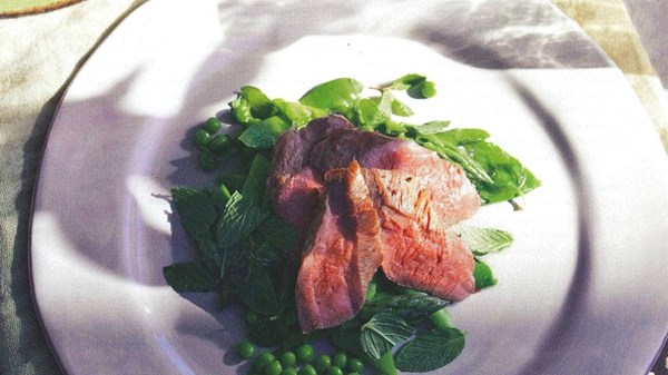 Poached lamb loin with spring vegetable medley