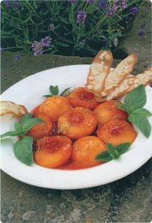 Poached peaches in lemon syrup with almond biscuits