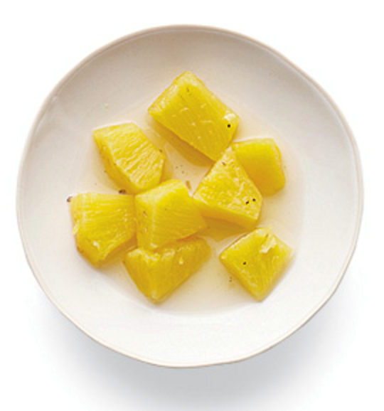Poached pineapple in white wine with rosemary and black pepper