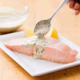 Poached salmon with dill and sour cream sauce